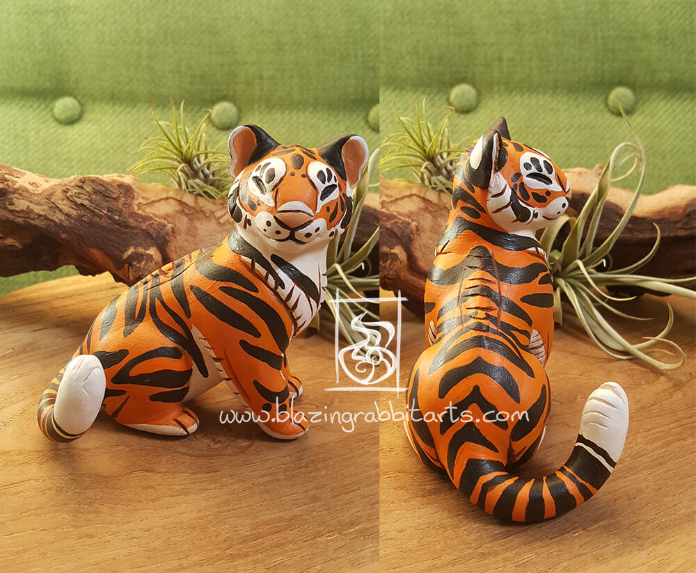 Sculpture of a tiger sitting.