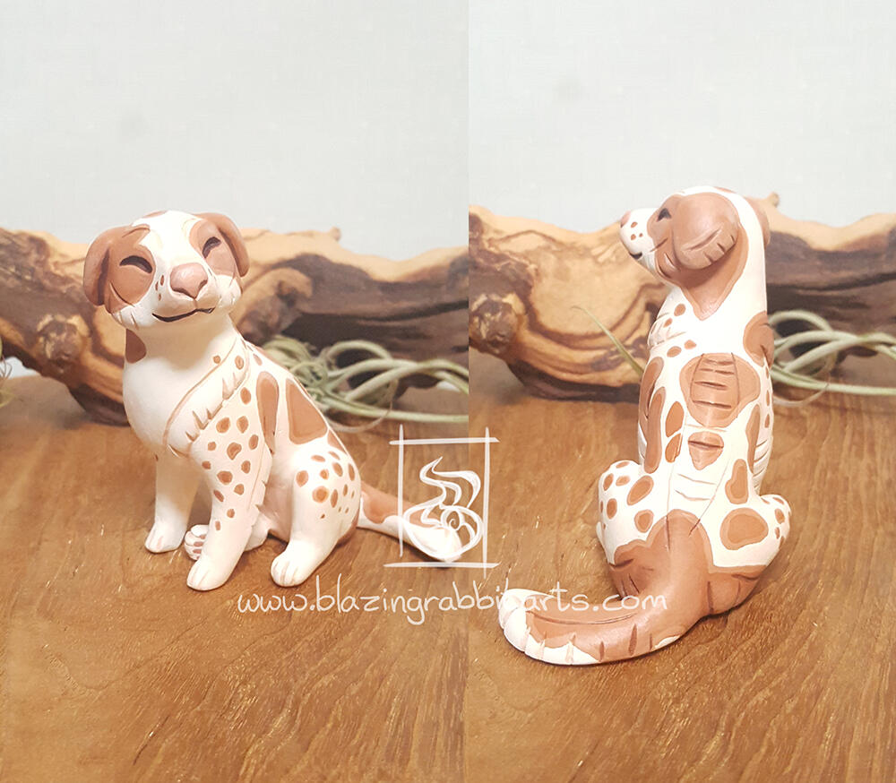 Sculpture of a dog sitting.
