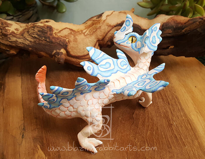 Sculpture of a pink and blue river dragon.